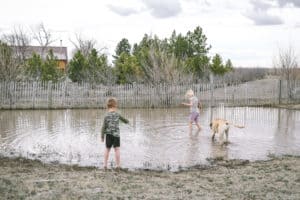 country kids in mud puddle